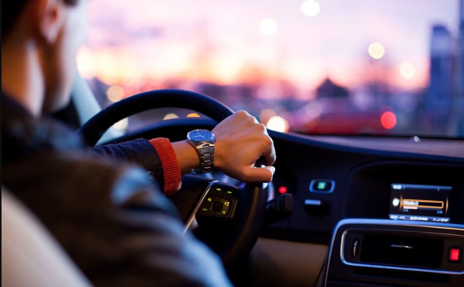 Chauffeur hands on the steering wheel during a comfortable private car journey